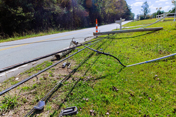 Strong hurricanes caused electrical poles to crash to ground with broken wires during strong winds
