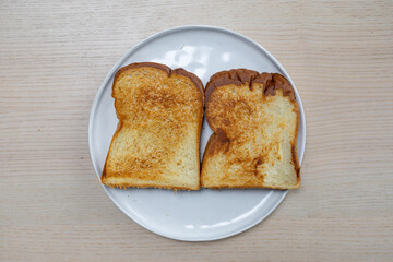 Two slices of toasted bread on a plate.