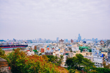 Fototapeta premium Kaohsiung, Taiwan, Republic of China, 01 25 2024: The landscape of Kaosiung port harbor, downtown, shiziwan (siziwan, xiziwan), and shoushan mountain seen from Qijin lighthouse