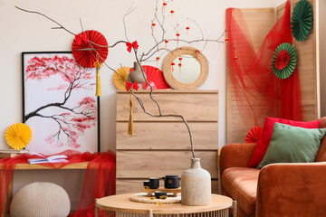 Interior of living room with sofa, table and decor for Chinese New Year celebration