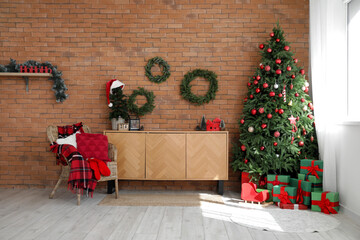 Interior of living room with Christmas trees, wreaths and armchair