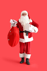 Santa Claus with Christmas bag and mailbox on red background