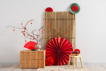 Interior of room with folding screen, stool and decor for Chinese New Year celebration