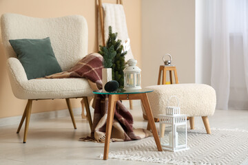 Armchair and Christmas lanterns in interior of living room