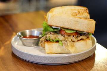 Chicken sandwich with tomato sauce.