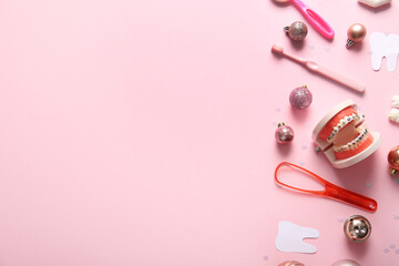 Obraz premium Composition with dentist's tools, paper teeth and Christmas decorations on pink background