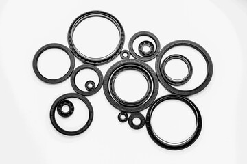 A collection of black rubber seals is displayed, showcasing different sizes and shapes ideal for...
