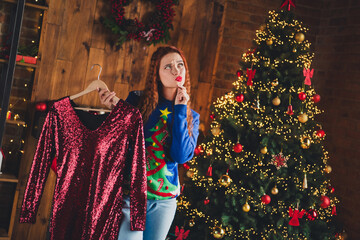 Photo of adorable lovely girl choose outfit glamour dress xmas eve preparation indoors