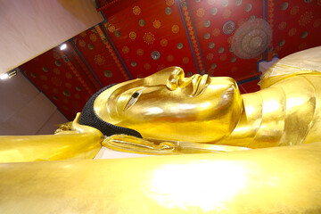 Close-up of the golden Buddha statue in a reclining position.