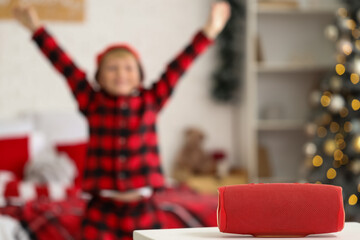 Portable speaker of little boy dancing in bedroom on Christmas eve, closeup