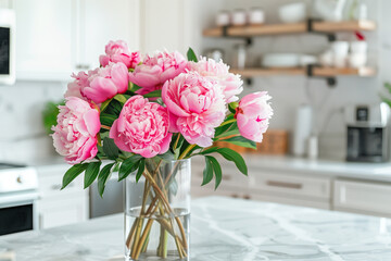 Beautiful Peonies in Vase on Granite Countertop Island in Stylish White Minimal Kitchen with Wooden Shelves in New House