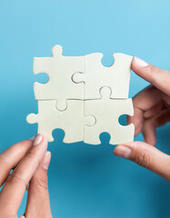 People holds in hand a jigsaw puzzle. Business solutions, success and strategy.
