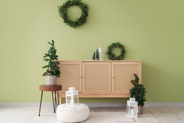 Interior of room with Christmas trees, wreaths and commode