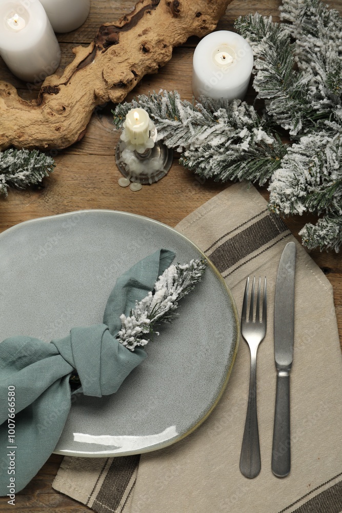 Poster Christmas place setting with plate, cutlery and festive decor on wooden table, flat lay