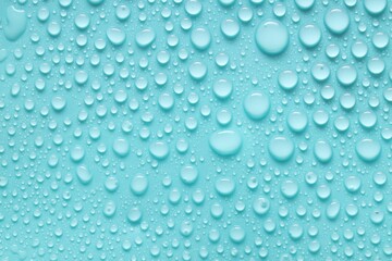 Water drops on turquoise background, above view