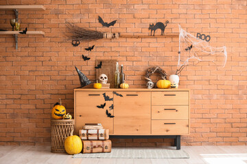 Stylish living room with chest of drawers decorated for Halloween celebration