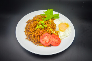 Indonesian fried noodle with vegetables and egg