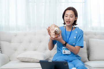 Fototapeta premium A medical professional in blue scrubs conducts an online lesson, holding a human head model to explain anatomy. This educational session provides medical training through virtual platforms.