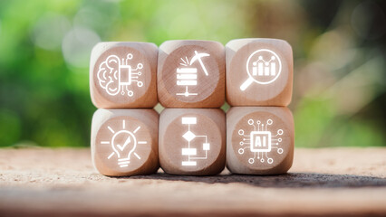 Wooden blocks with icons representing predictive analytics, data mining, AI, and machine learning, symbolizing modern data analysis and technology.