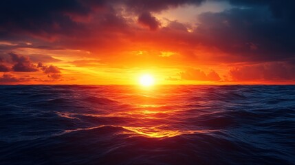 Obraz premium Stunning sunset over ocean waves with vibrant orange and blue skies.