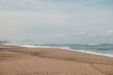 Big waves suitable for surfing in the tropical country the Philippines. Very fine white sand beach