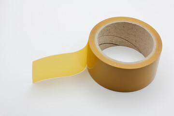 Roll of yellow duct tape on a white background