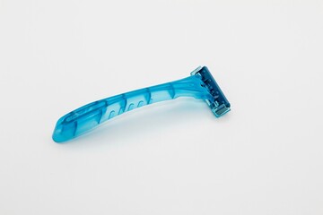 Blue disposable razor blade isolated on white background. Single use razor blade. Disposable shaving razor.