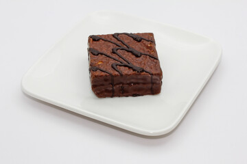 delicious chocolate cake on a white plate. square chocolate cake