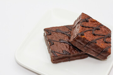 delicious chocolate cake on a white plate. square chocolate cake