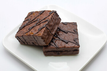 delicious chocolate cake on a white plate. square chocolate cake
