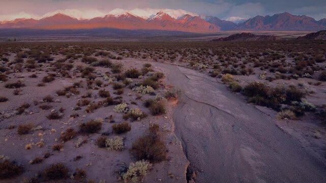 Snowcapped Andes mountains at dawn near Uspallata, Argentina. Aerial view, drone flyby.