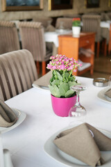 A Charming Restaurant Table Featuring a Beautiful Flower Centerpiece and Elegant Setting Decor