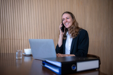 Businesswoman wear casual suite working at office laptop online, checking emails and document planning on the monitor with a cup of coffee actively organizing business concept.