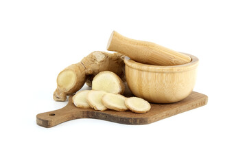 Sliced ginger root with mortar and pestle isolated on white background