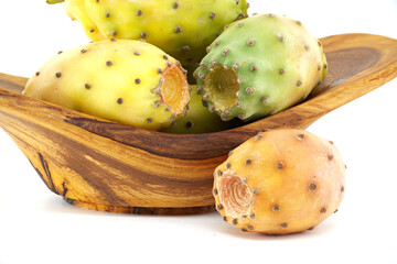 Fresh prickly pear fruit in wooden bowl on white background