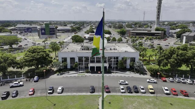 Drone slowly flies backwards from Roraima flag in Pra&ccedil;a Centro Civico in Boa Vista, Roraima, Brazil