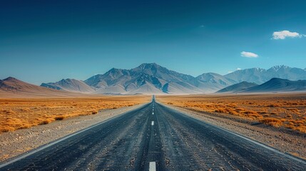 Fototapeta premium A lonely road stretches towards snow-capped mountains under a blue sky. AI generative. .