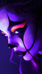 Obraz premium Apply UV-reactive face paint to the model and shoot under blacklight for an ethereal look