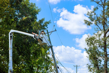An emergency response team is working to restore power following severe hurricane that damaged...