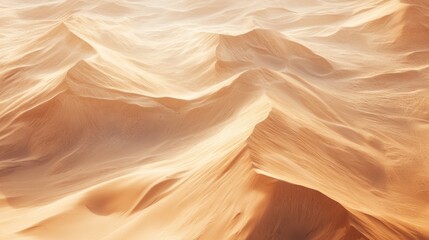 Obraz premium Aerial view of undulating sand dunes in warm tones, showcasing natural patterns and textures.