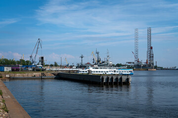 View of the pier for boat trips along the Gulf of Finland on the Kronstadt embankment on a sunny summer day, Kronstadt, St. Petersburg, Russia