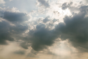 sun shines on a dramatic sky with ominous clouds after thunderstorm.