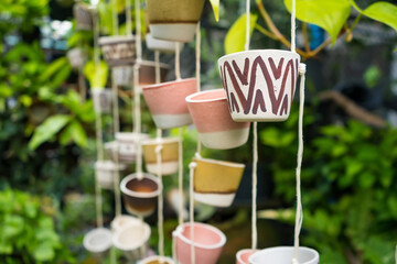 Hanging Pottery Planters in garden.