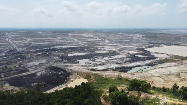 Aerial view panorama of open pit coal mining, dumper, extractive industry excavation, very large mine. Big Yellow Mining Truck