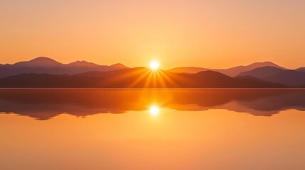 Fototapeta premium Majestic Sunset Over Serene Lake - Vibrant Golden and Orange Hues with Mountain Silhouettes Reflecting in Water