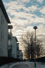 Silhouette of a Person Walking at Sunset with Winter Buildings
