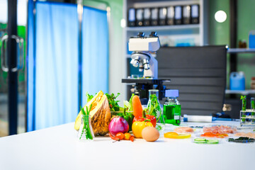A detailed research concept in laboratory table setting, focused on food ingredients vegetables and meat. Test tubes, microscopes, lab equipment used to analyze nutritional extracts and vitamins.