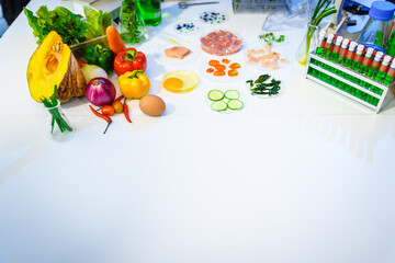 A detailed research concept in laboratory table setting, focused on food ingredients vegetables and meat. Test tubes, microscopes, lab equipment used to analyze nutritional extracts and vitamins.