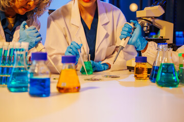 middle-aged man, an old woman, and a young woman collaborate in a lab at night, under blue and RGB...