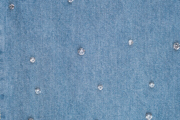 Decorative denim fabric with sparkly embellishments showcases modern fashion trends